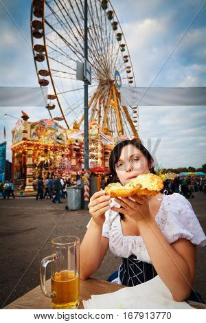 young woman having a snack at the carnival