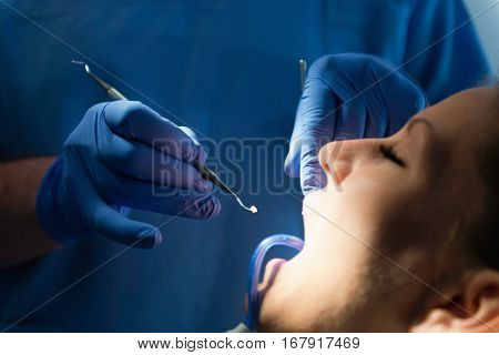 Dental filling female patient's tooth, toned image