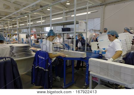 ST. PETERSBURG, RUSSIA - NOVEMBER 2, 2016: People at work in the department of packaging of products of StarLine company. It is one of the leading company on the automotive security market of Russia