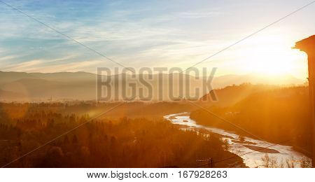 Bolzano Italy - view of forest mountains and creek near Bozen at sunset