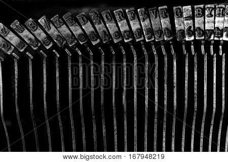 Closeup of old typewriter plates strikers strykers with letters and symbols for typing