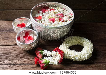 Water in bowl mixed with perfume and flowers corolla for Songkran festival in Thailand.