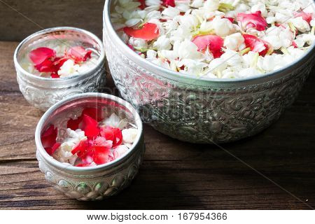 Water in bowl mixed with perfume and flowers corolla for Songkran festival in Thailand.