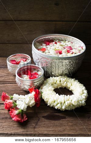 Water in bowl mixed with perfume and flowers corolla for Songkran festival in Thailand.