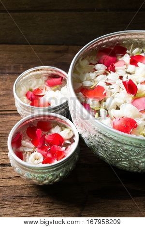 Water in bowl mixed with perfume and flowers corolla for Songkran festival in Thailand.