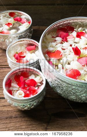 Water in bowl mixed with perfume and flowers corolla for Songkran festival in Thailand.