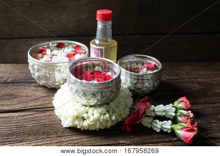 Water in bowl mixed with perfume and flowers corolla for Songkran festival in Thailand.