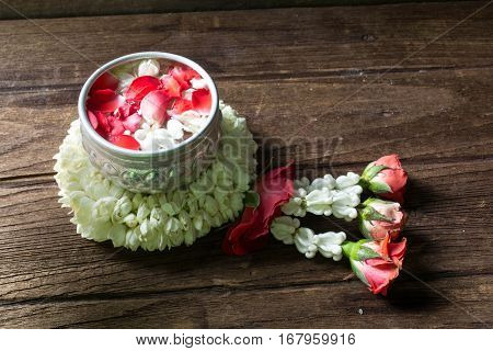 Water in bowl mixed with perfume and flowers corolla for Songkran festival in Thailand.