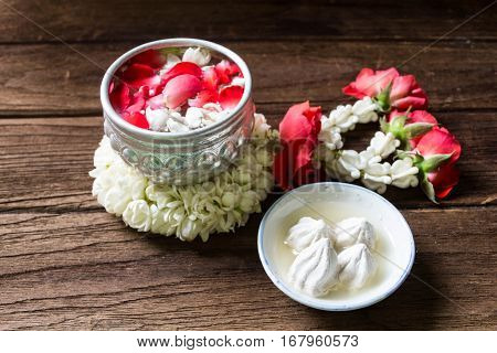 Water in bowl mixed with perfume and flowers corolla for Songkran festival in Thailand.