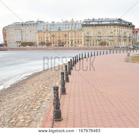 View of Frozen Neva River and Petrograd side in center of St.Petersburg at cloudy winter day Russia.