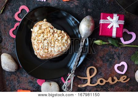 Valentine's day gift on hotel restaraunt on black table.