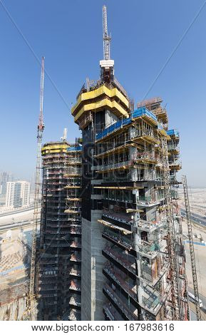 United Arab Emirates, Dubai, 05/21/2015, Damac Towers Dubai by Paramount, construction and building ariel views with cityscape background