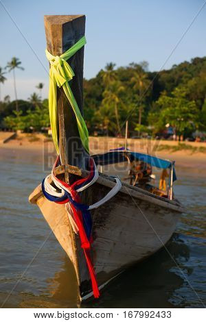 Thai wooden boat with motor at sunset