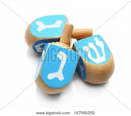 Wooden dreidels for Hanukkah on white background