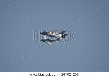 North American P-51 Mustang And Lockheed Martin F-35 Lightning Ii Flying Side By Side In A Heritage 