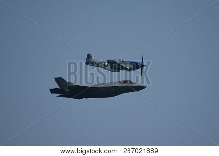 North American P-51 Mustang And Lockheed Martin F-35 Lightning Ii Flying Side By Side In A Heritage 