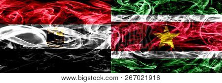 Egypt, Egyptian Vs Suriname, Surinamese Smoke Flags Placed Side By Side. Thick Abstract Colored Silk