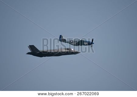 North American P-51 Mustang And Lockheed Martin F-35 Lightning Ii Flying Side By Side In A Heritage 