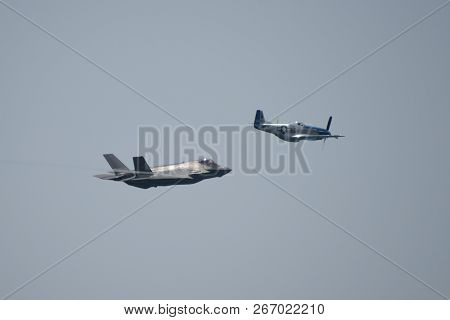 North American P-51 Mustang And Lockheed Martin F-35 Lightning Ii Flying Side By Side In A Heritage 