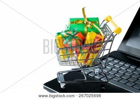 Ciber Monday Concept - Trolley Cart With Christmas Presents On Notebook, Isolated On White