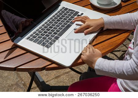 Detail Of Little Girl Finger Hand Surfing On Laptop Trackpad