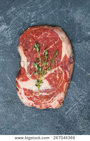 Beef Steak With Thyme On Grey Background