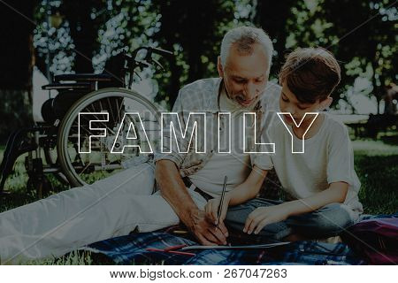 Boy And Grandfather Draw In Notbook. Family Picnic. Relatives Have Fun. Family Meeting In Park. Smil
