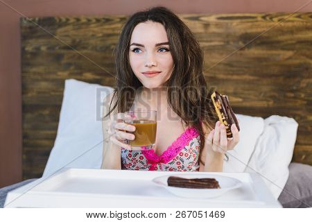 Girl With Cake In Bed Drinking Coffee