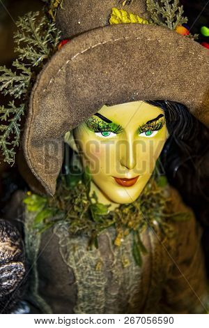 Witchy Halloween Decoration - Detail Of Beautiful Earth Witch In Brown Costume And Hat With Very Gre
