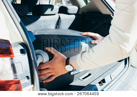 Partial View Of Man Putting Baggage Into Car, Travel Concept