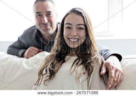Teenager Girl Sitting On Window With Father