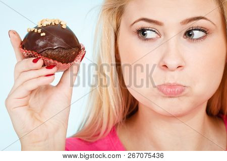 Diet, Sweets, Food Concept. Woman Holding Delicious Chocolate Cupcake With Peanut Frosting About To 