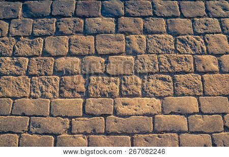Cobblestone Pavement Background With Copy Space. Abstract Old Close-up Cobble Stone Texture. Pavings