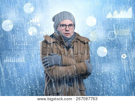 Young businessman shivering with graphs, reports and chart concept