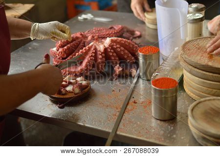 Cooks Chopping Octopus At Becerrea Octopus Fair. Cooking, Food, Travel, Professions, Jobs. August 3,