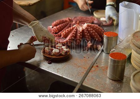 Cooks Chopping Octopus At Becerrea Octopus Fair. Cooking, Food, Travel, Professions, Jobs. August 3,