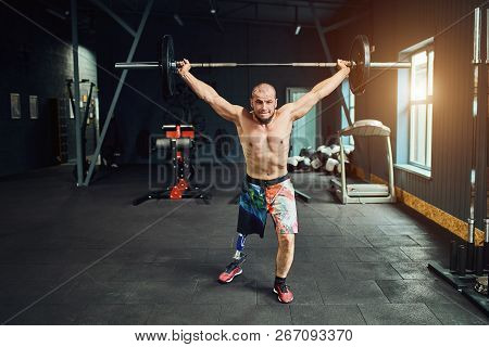 Sportsman With Prosthesis Working Out In Gym