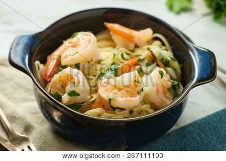 Shrimp Scampi With Angel Hair Pasta Surrounded By Cooking Ingredients