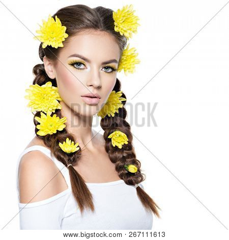 Beautiful stylish woman with long pigtails and  bright yellow make-up. Fashion portrait. Attractive girl with stylish hairstyle, pigtails -   isolated on white. Professional  makeup. Art hairstyle. 