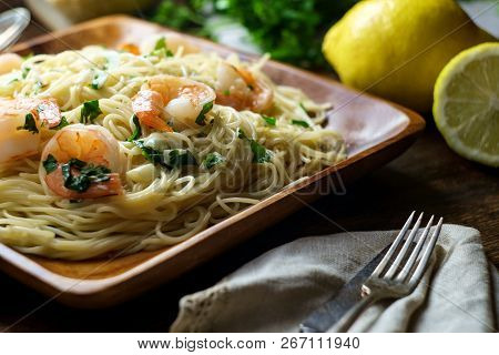 Shrimp Scampi With Angel Hair Pasta Surrounded By Cooking Ingredients