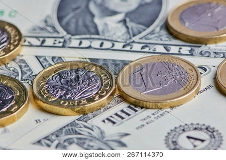 British Pound, Euro Coins And Us Dollar Banknotes In A Horizontal Color Macro Picture