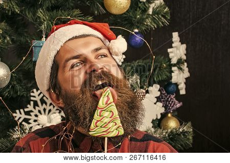 Christmas Man With Beard On Happy Face And Lollipop. Santa Claus Man In Hat At Decoration. Party Cel