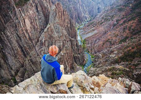 Tourist on the granite cliffs of the Black Canyon of the Gunnison, Colorado, USA