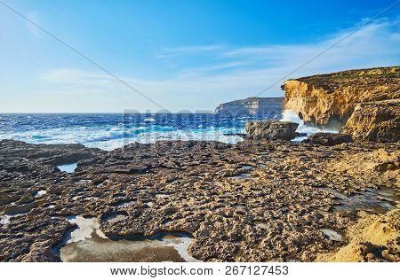 The Mountain Landscape Of San Lawrenz Coast With A View On Stormy Waves, Crashing Against The Rocks 