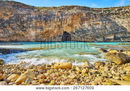 The Dwejra Inland Sea With Tall Cliffs, Rocky Shores, Tiny Beach And Blu Hole Pass In Rock, Connecti