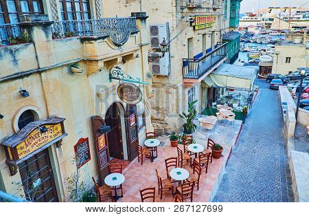 Ghajnsielem, Malta - June 15, 2018: The Coastal Neighborhood, Surrounding The Mgarr Harbour, Is Occu