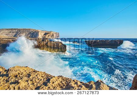 The Scenic Rocky Landscape Of Gozo Coast With Strong Foamy Waves, Crashing Against The Shore, San La