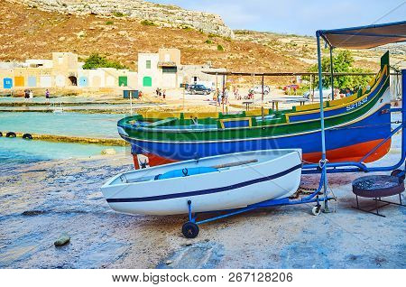 San Lawrenz, Malta - June 15, 2018: The Fishing Boats On Shore Of Dwejra Inland Sea With Old Stone B
