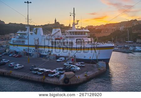 Ghajnsielem, Malta - June 15, 2018: The Evening Departing From The Ferry Terminal With A View On Mga