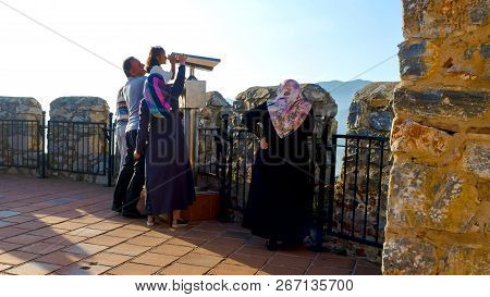 Konakli, Alanya - 06 July 2018: Arab Family Of Tourists On Viewing Platform With Binocular Near Fort